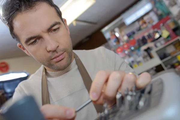 Looking at a tiny tube — Stock Photo, Image