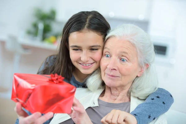Giving grandma a gift — Stock Photo, Image