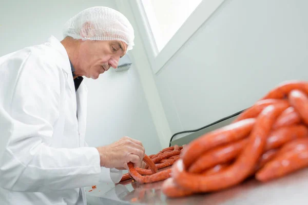 Butcher making sausages and butcher — Stock Photo, Image