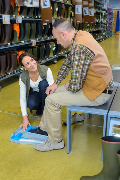 Man having feet measured