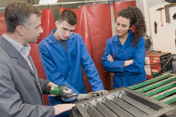 Lehrlinge beobachten Lehrer in Werkstatt — Stockfoto