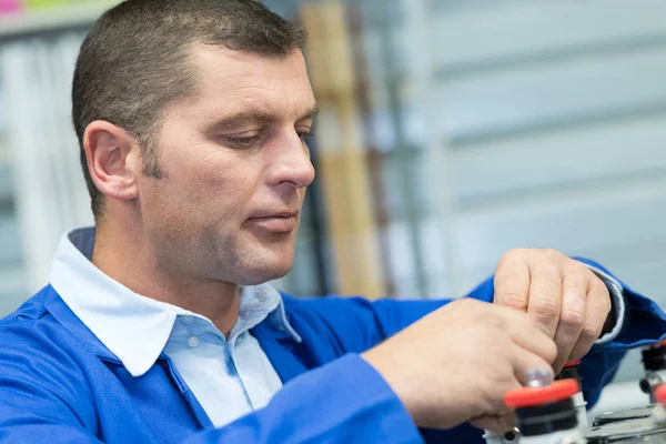 Workman concentrating on his job — Stock Photo, Image