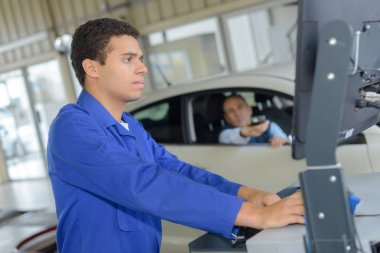 Mechanics working in vehicle test station clipart