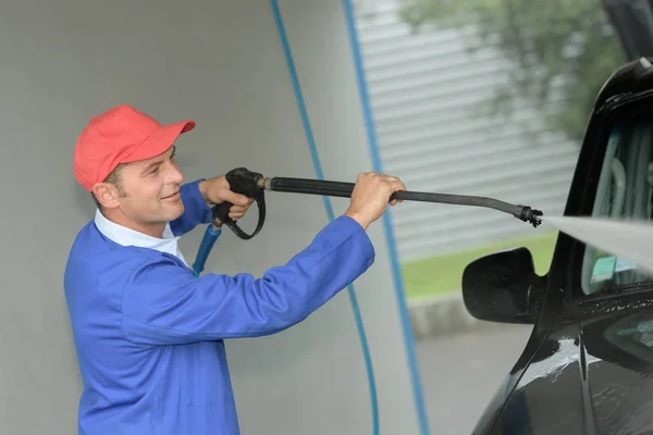 Werknemer auto met macht wasmachine schoonmaken — Stockfoto