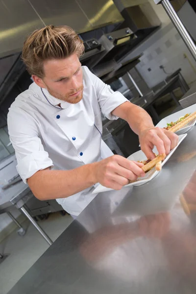 Chef-kok plating voedsel en chef-kok — Stockfoto