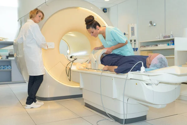 Nurse setting up scanning machine patient is layed on — Stock Photo, Image