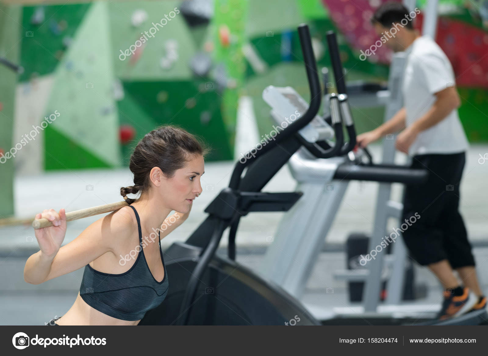Lady Doing Fitness Routine Using Wooden Stick Stock Photo Lady Doing Fitness Routine Using Wooden Stick Stock Photo