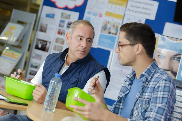 Mannen eten uit groene kommen — Stockfoto