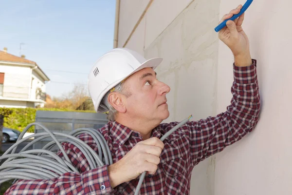 Homme travaillant avec des câbles à l'extérieur — Photo