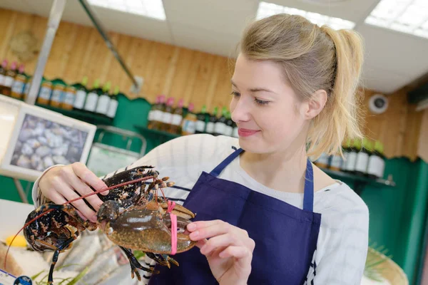 Fishmonger holding lobster and lobster — Stock Photo, Image