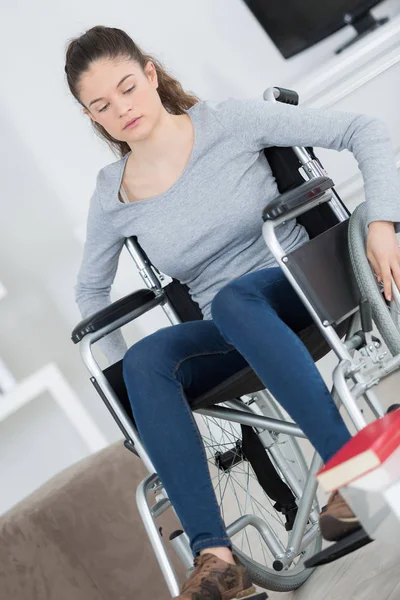 Sad girl in wheelchair at home — Stock Photo, Image