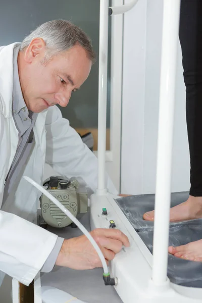 Médico verificando problemas com o pé — Fotografia de Stock