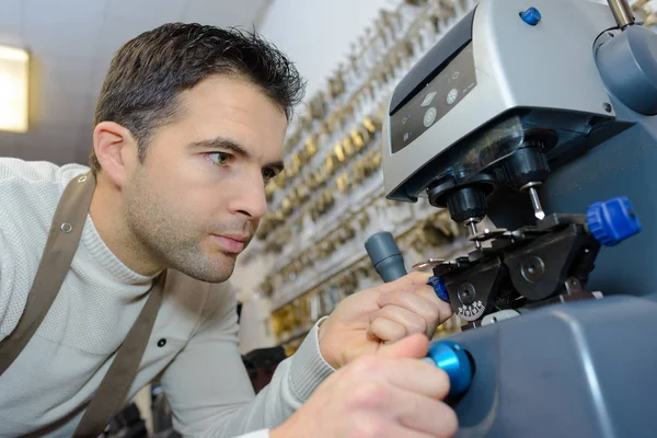 Young professional with different types of keys in locksmith — Stock Photo, Image