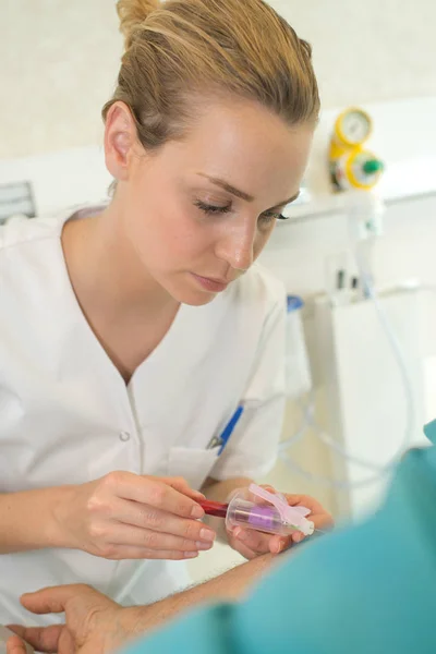 Nurse taking a blood sample from patient — Stock Photo, Image