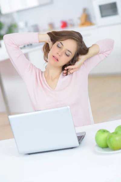 Tired woman with laptop computer — Stock Photo, Image