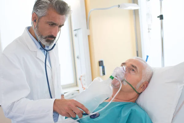 Senior patienten att göra inandning med nebulisator i examen rummet — Stockfoto