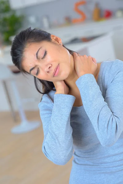 Beautifull woman holding her neck because of pain — Stock Photo, Image