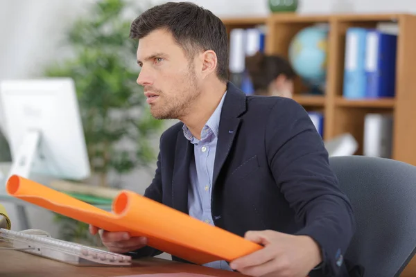 Architect working with blueprints in the office — Stock Photo, Image