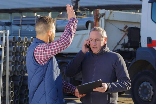 Deux travailleurs travaillant à l'extérieur sur un chantier — Photo