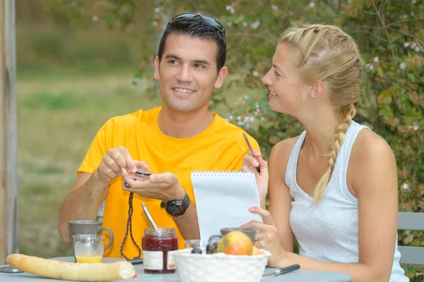 Foto de pareja joven desayunando en el jardín —  Fotos de Stock