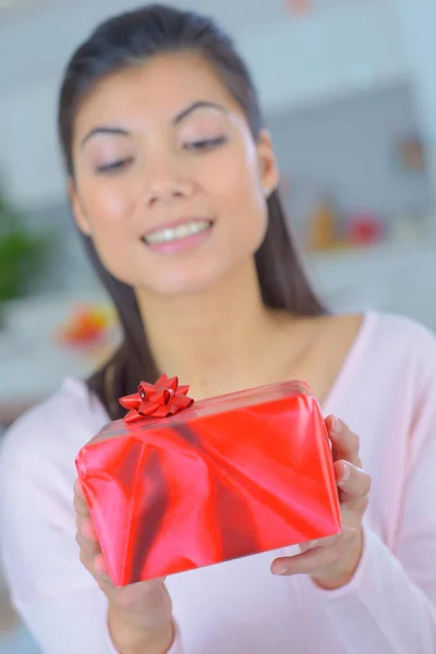 Portrait of young female hold gifts on background — Stock Photo, Image