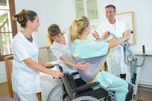 Caring male doctor greeting handicapped patient — Stock Photo, Image