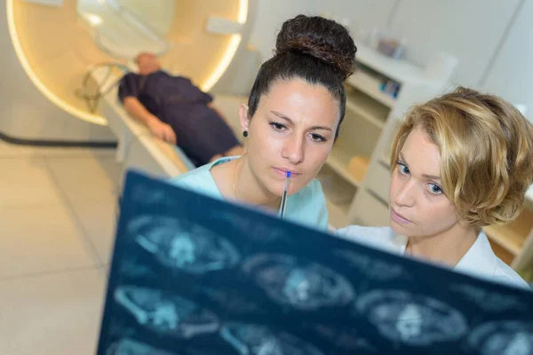 여성 의사와 간호사는 x-레이를 보고 — 스톡 사진
