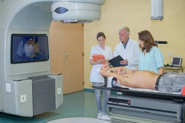 Médico explicando paciente resonancia magnética en pantalla —  Fotos de Stock