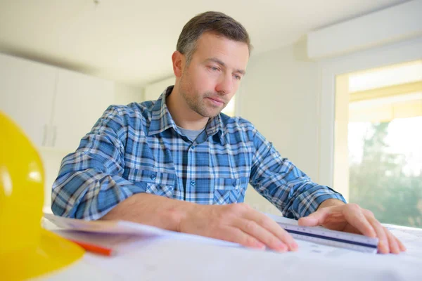 Male architect working on blueprints — Stock Photo, Image
