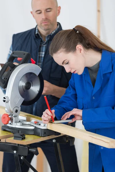 Schrijnwerker en vrouwelijke leerling — Stockfoto