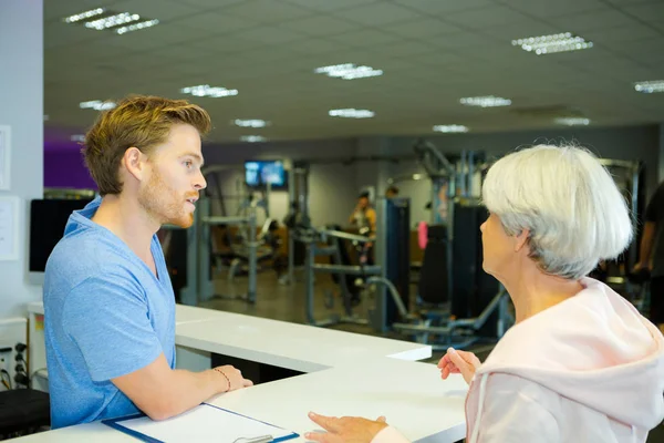 Ανώτερος γυναίκα την εγγραφή στο health club — Φωτογραφία Αρχείου