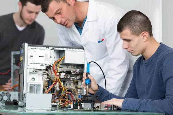 Student in technology fixing computer processing — Stock Photo, Image
