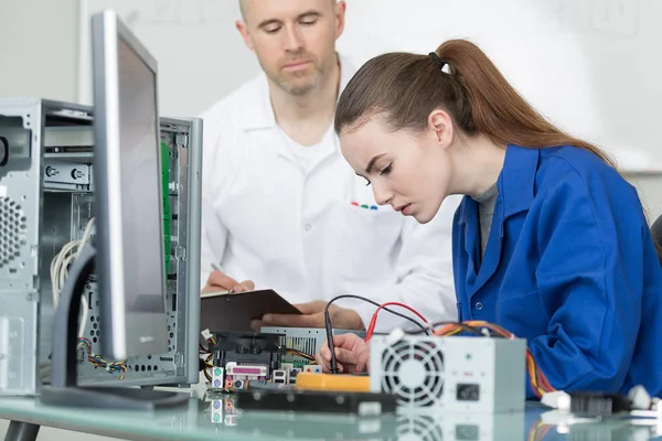 Teacher with student in technology repairing computer — Stock Photo, Image