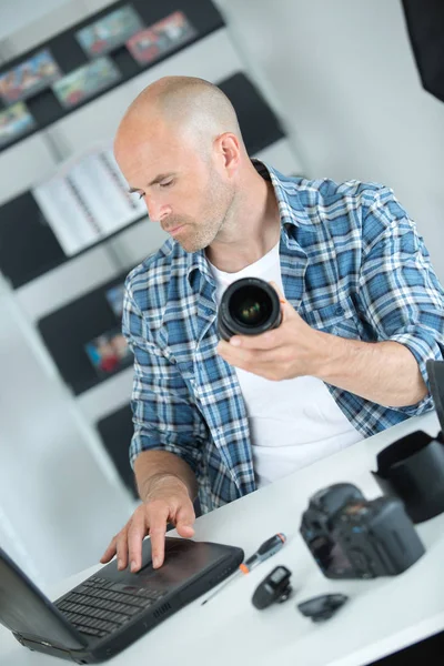 Fotógrafo com câmera digital moderna dslr e laptop — Fotografia de Stock