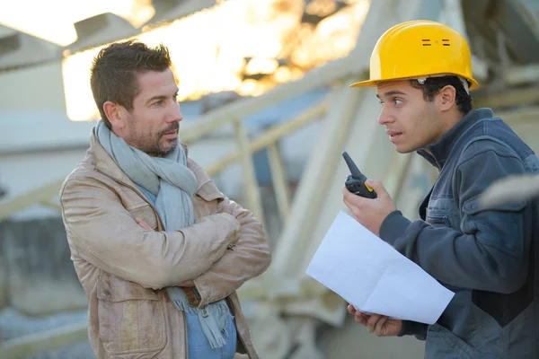 Przedsiębiorca i budowniczy na budowie za pomocą walkie talkie — Zdjęcie stockowe