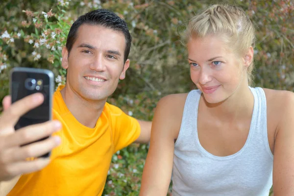 Athletic healthy cheerful couple making selfie after training — Stock Photo, Image