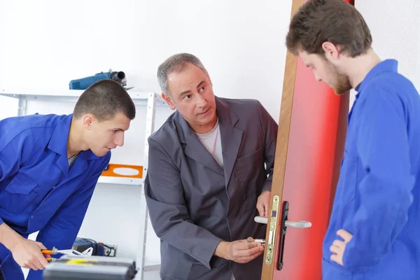 Young apprentices with mentor locksmith — Stock Photo, Image