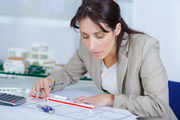 Architect drawing blueprints using technical pen — Stock Photo, Image