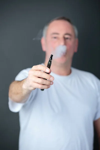 Man smokes electronic cigarette — Stock Photo, Image