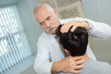 physical therapist examines a patients neck clipart