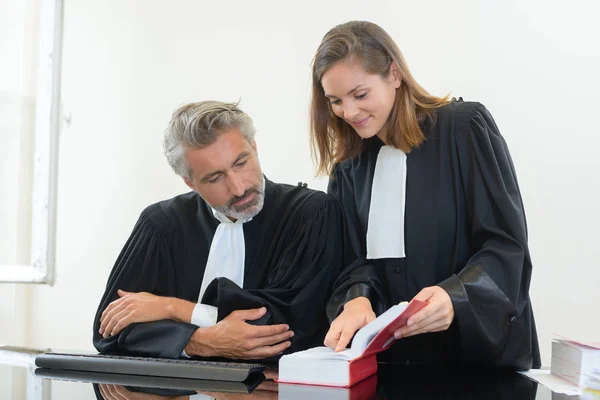 Dois juízes olhando para o livro de leis — Fotografia de Stock