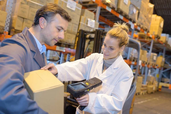 warehouse management system worker with barcode scanner