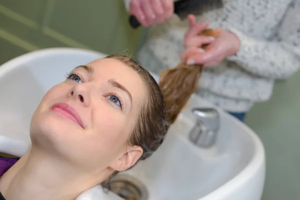 Kobieta, mycie głowy w salon fryzjerski — Zdjęcie stockowe