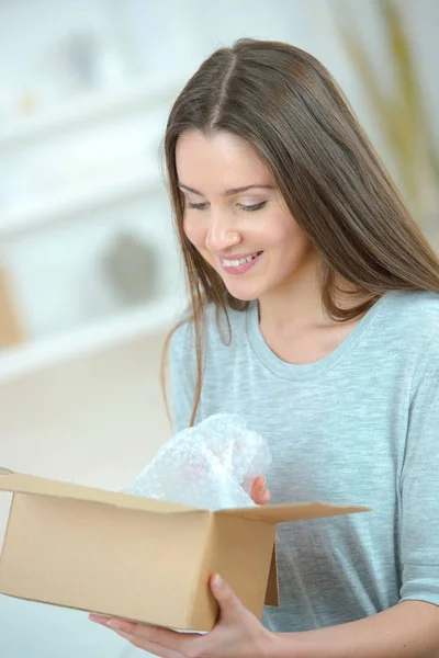 Surprised young woman after she open her present — Stock Photo, Image