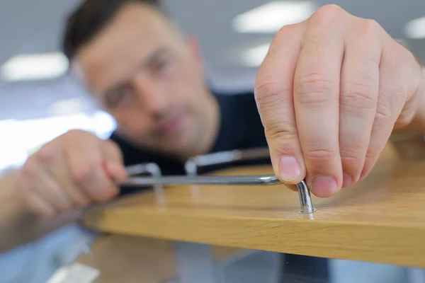 Handsome man assembling cabinet — Stock Photo, Image