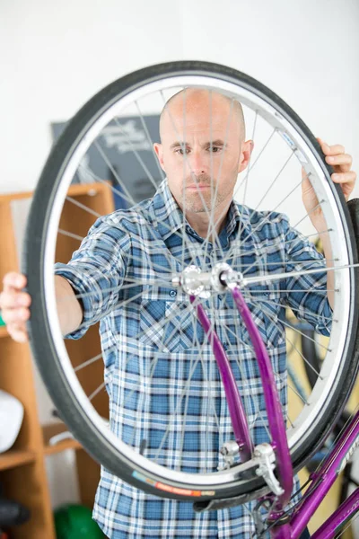 Hombre trabajando en taller de bicicleta — Foto de Stock