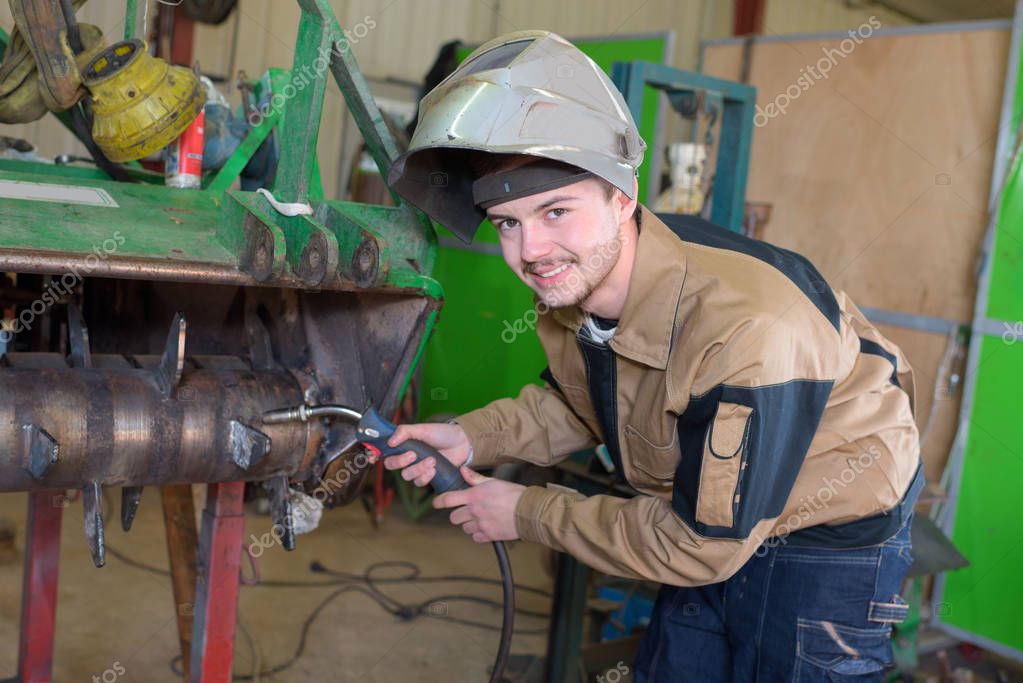 happy apprentice welder at work in the plant stock photo apprentice welder
