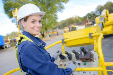 female engineer crane operator on construction site clipart