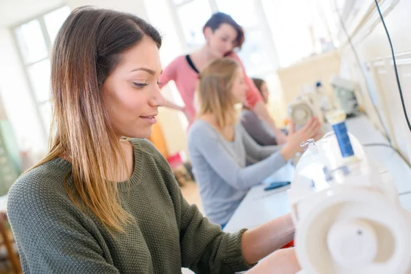 Young people using sewing machine — Stock Photo, Image