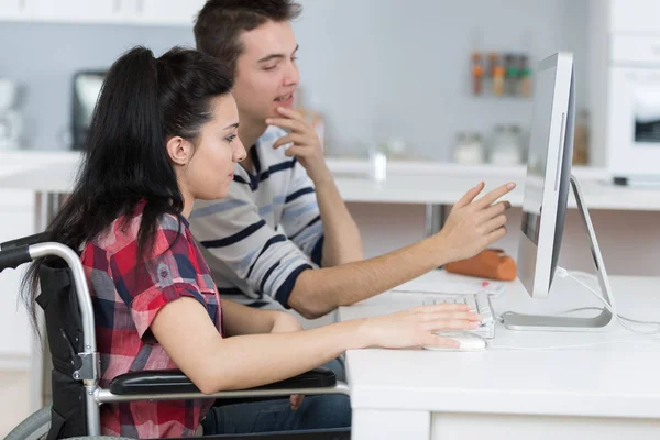 Two teenagers studying at home handicaped girl — Stock Photo, Image